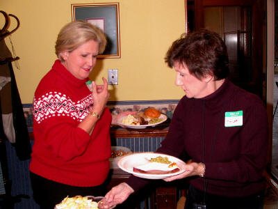 "Hey guys! We have a lot of people to feed here!" Sue McCumbers and Marijon Meadows help themselves to the great food that was being served.